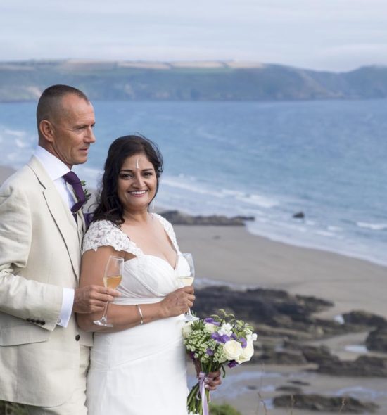 Bride and groom enjoy a moment on the cliffs in Cornwall on their wedding day